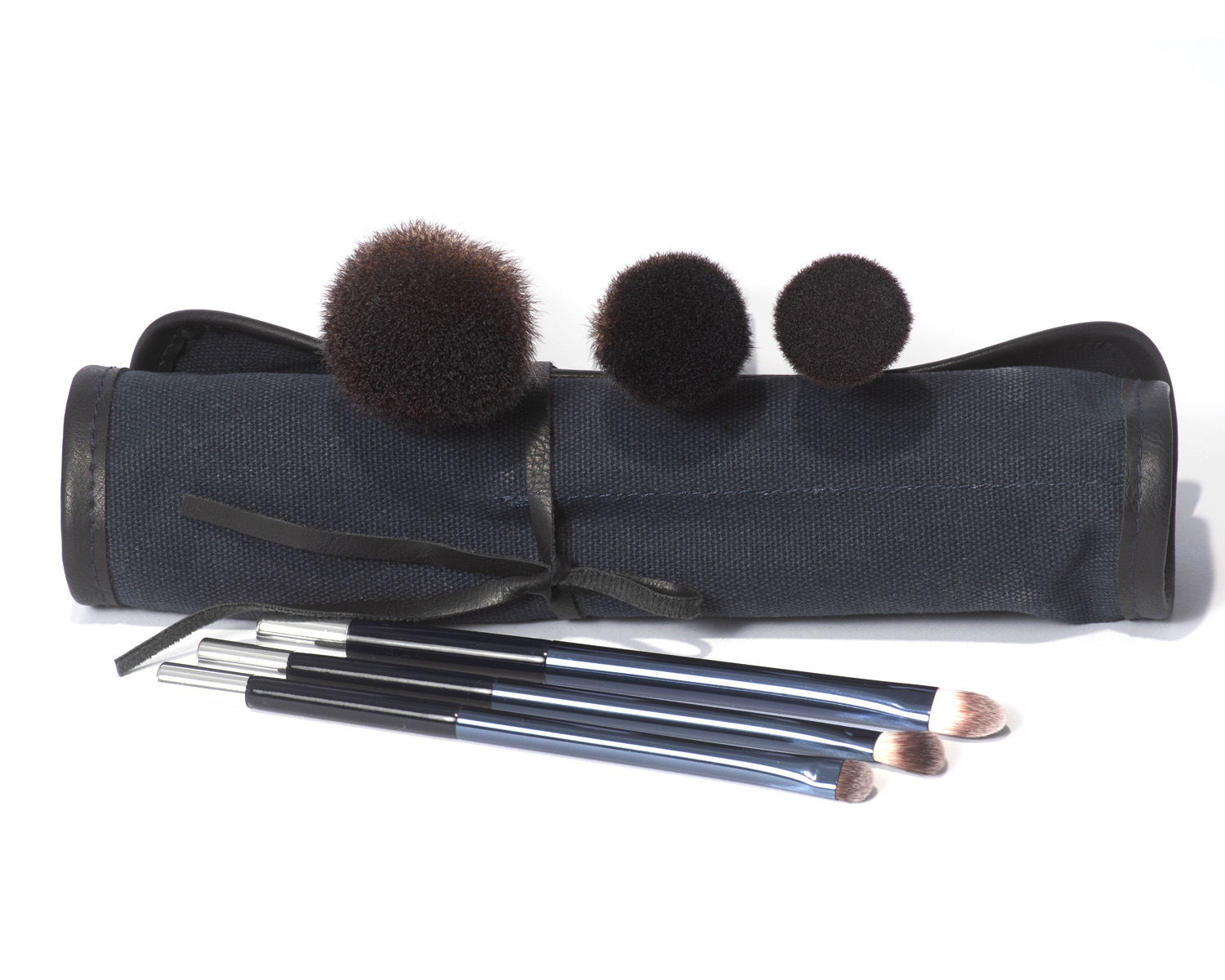 Dark blue canvas roll-up makeup 6 brush set for applying bronzer, blusher, bb cream, concealer, kajal pencil and eyeshadow.